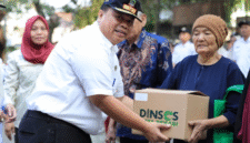 Kepala Dinsos Kota Bekasi saat menyerahkan bantuan